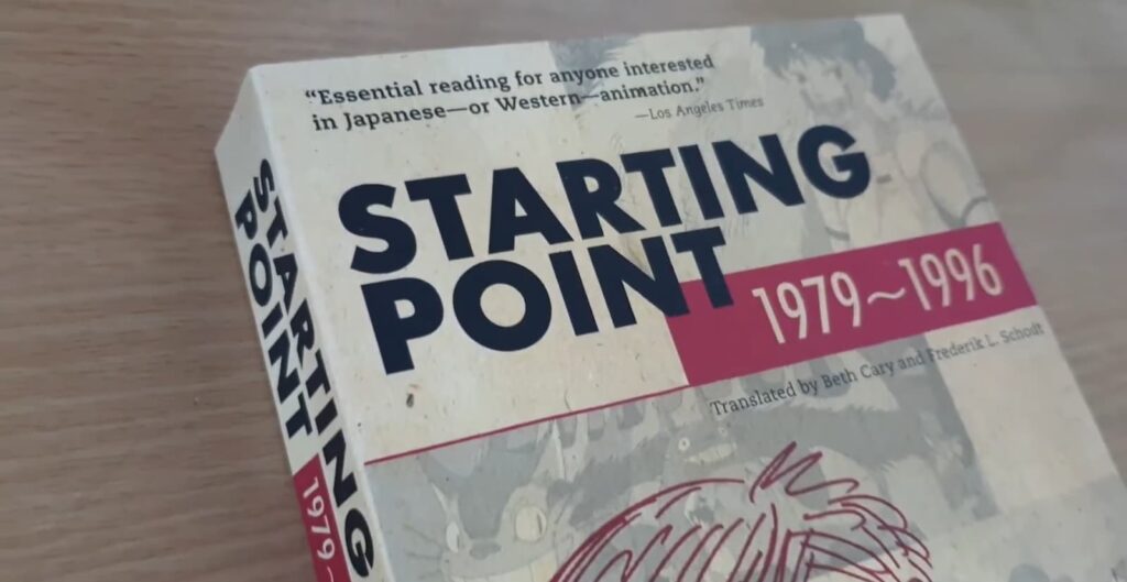 A worn book titled "STARTING POINT 1979-1996" with a sketched figure on the cover