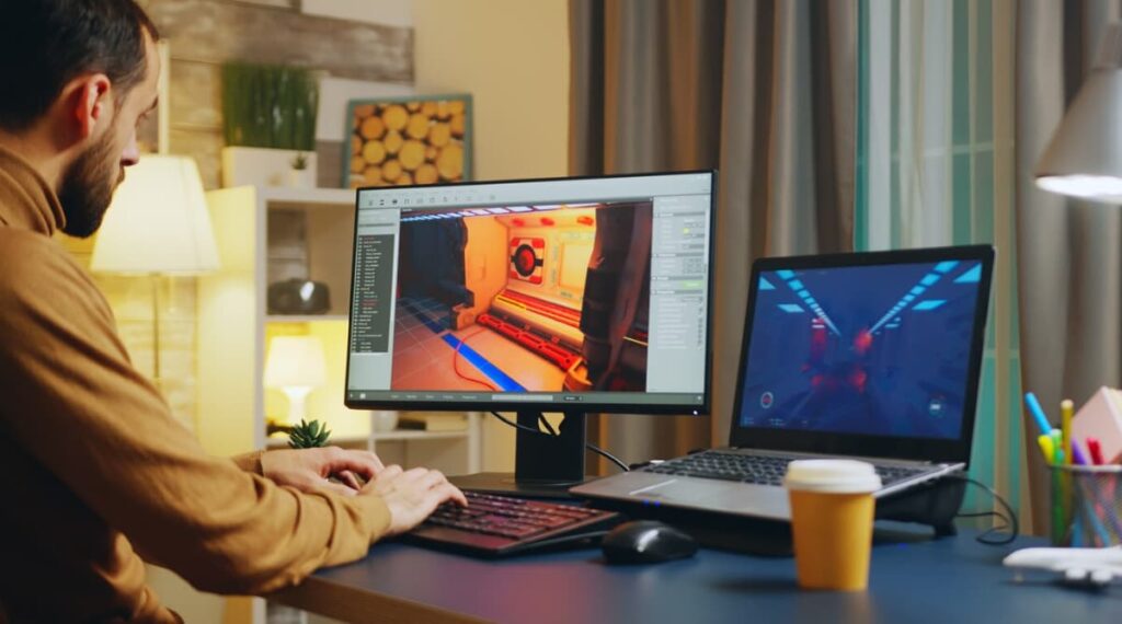 A man works on 3D modeling on two screens in a cozy room