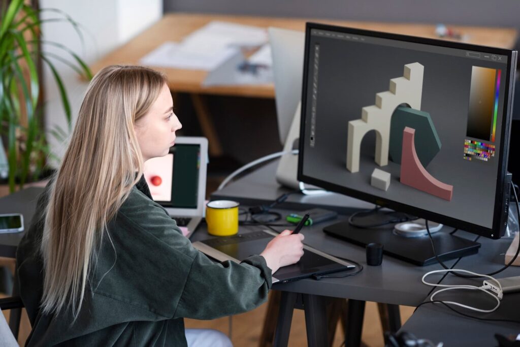 A girl sits at the computer and does a project